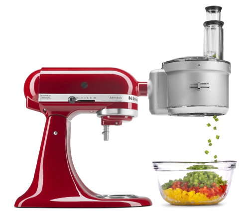 Red stand mixer with food processor attachment dicing peppers in to a bowl