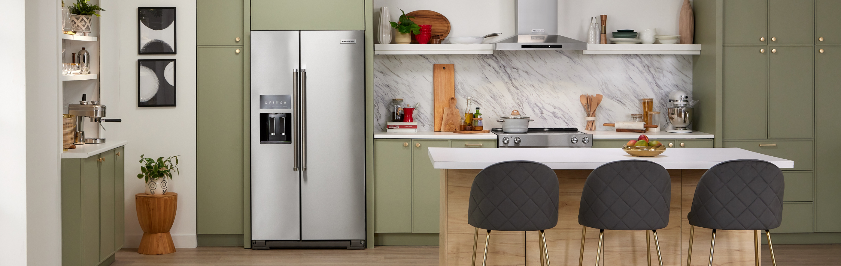 KitchenAid® side-by-side refrigerator built into green cabinetry