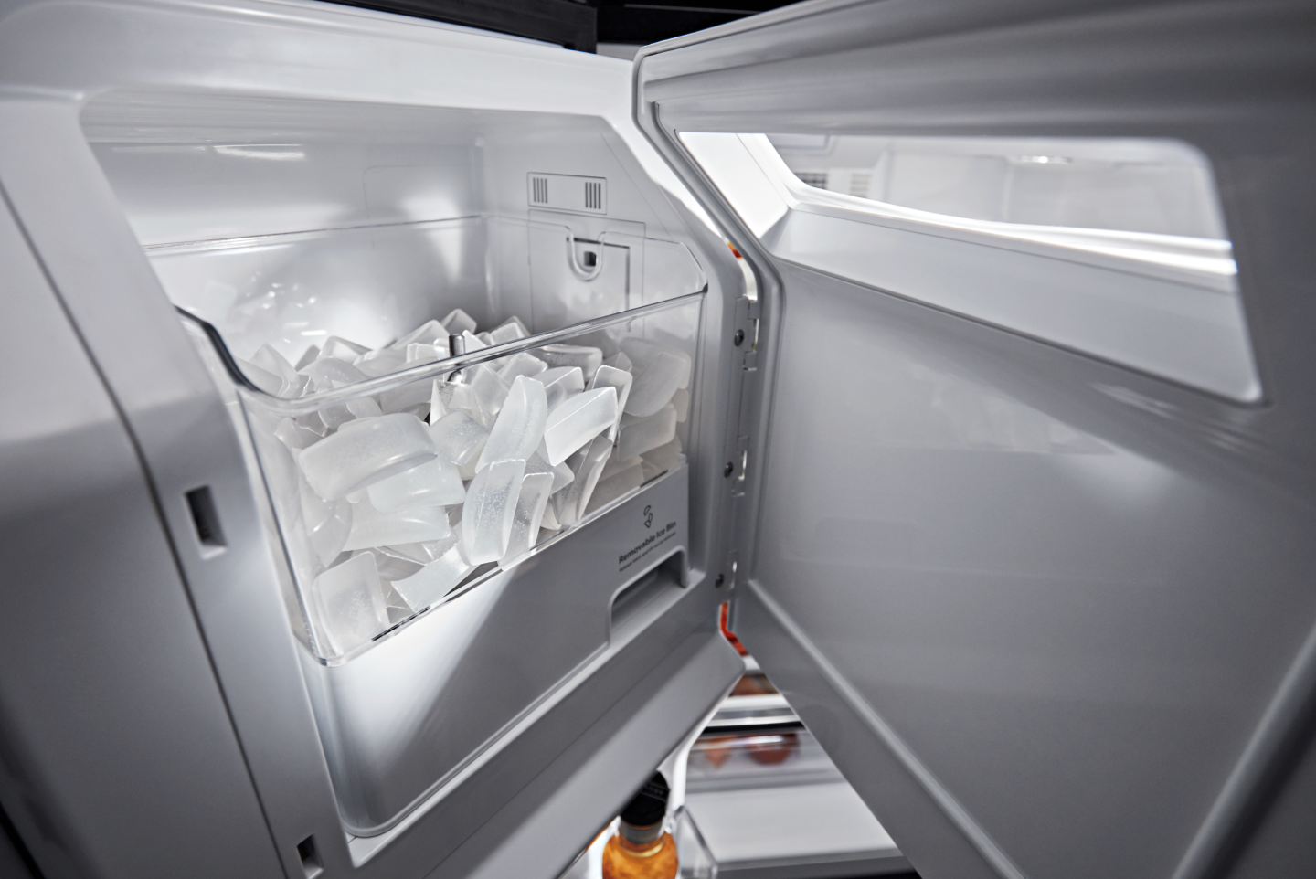 Open in-door ice maker full of ice Open in-door ice maker full of ice