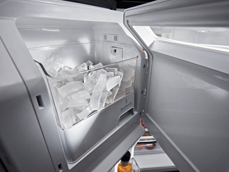 Open in-door ice maker full of ice Open in-door ice maker full of ice