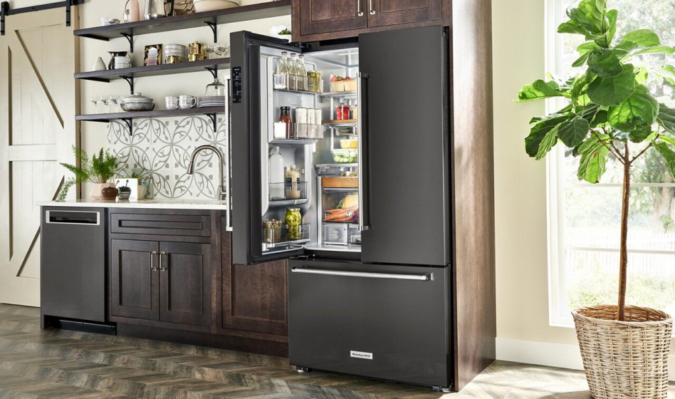 French door refrigerator in kitchen with one door open French door refrigerator in kitchen with one door open