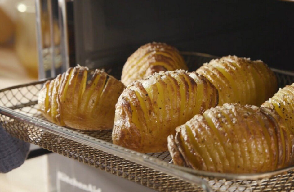 Close up of roasted potatoes in an air fryer basket Close up of roasted potatoes in an air fryer basket