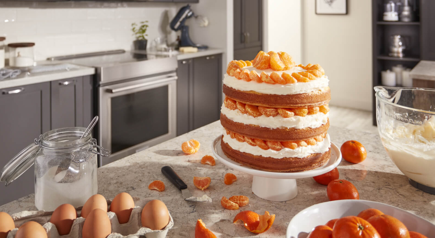A layered cake with tangerines and cream A layered cake with tangerines and cream