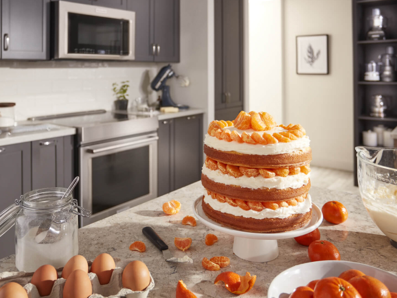 A layered cake with tangerines and cream A layered cake with tangerines and cream