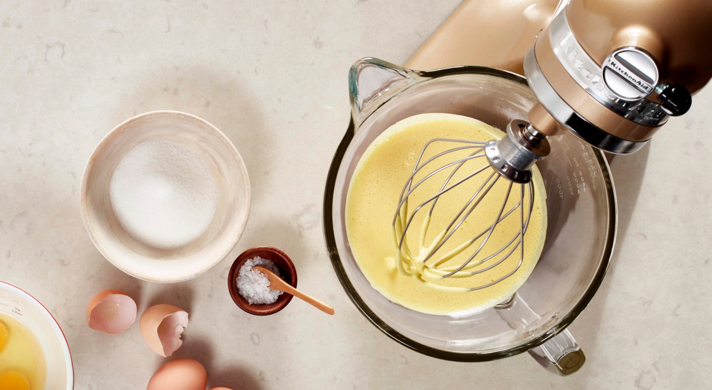 Homemade mayo in a stand mixer next to a bowl of sugar Homemade mayo in a stand mixer next to a bowl of sugar