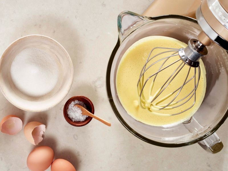 Homemade mayo in a stand mixer next to a bowl of sugar Homemade mayo in a stand mixer next to a bowl of sugar