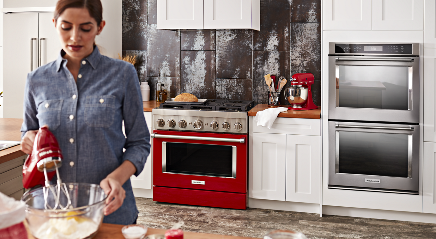 Woman mixing ingredients for homemade bread with KitchenAid® hand mixer Woman mixing ingredients for homemade bread with KitchenAid® hand mixer