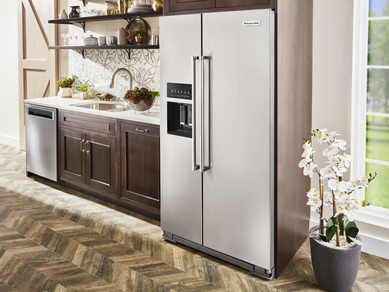 KitchenAid® side-by-side refrigerator in kitchen with brown cabinetry KitchenAid® side-by-side refrigerator in kitchen with brown cabinetry