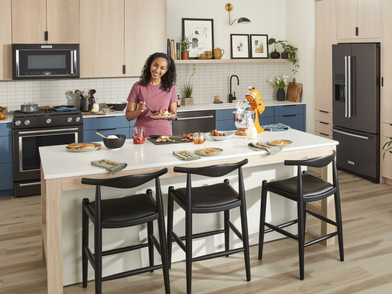 Person preparing place settings at kitchen island