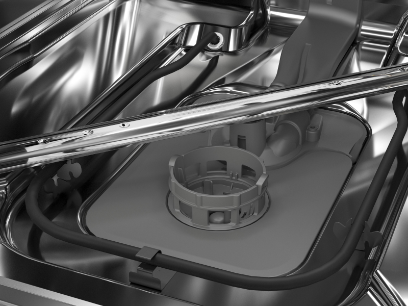 A closeup of a spray arm at the base of a KitchenAid® dishwasher.