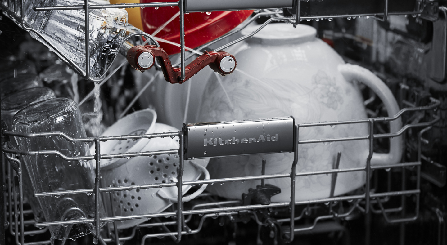 A closeup of the bottom rack of a KitchenAid® dishwasher with dishware. A closeup of the bottom rack of a KitchenAid® dishwasher with dishware.