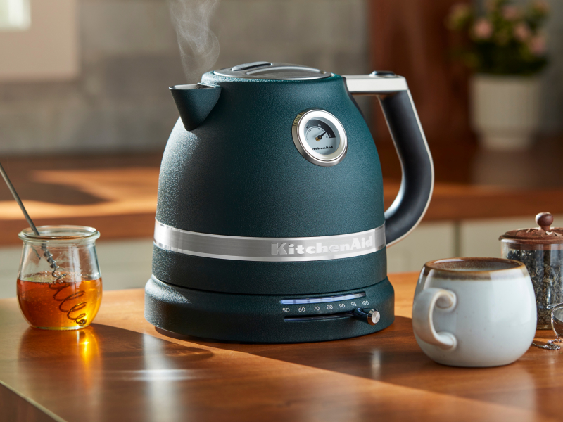Teal KitchenAid® electric kettle next to tea and honey Teal KitchenAid® electric kettle next to tea and honey