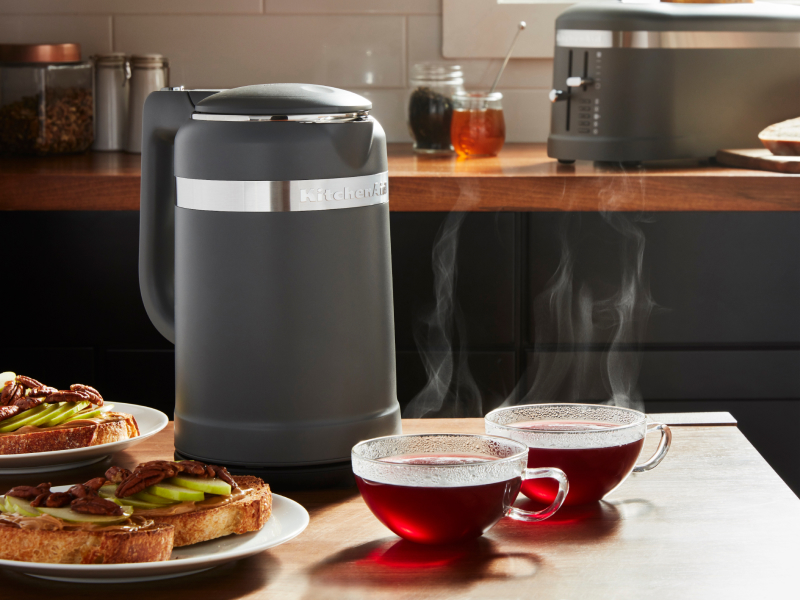 Black KitchenAid® electric kettle next to two glass mugs of tea Black KitchenAid® electric kettle next to two glass mugs of tea