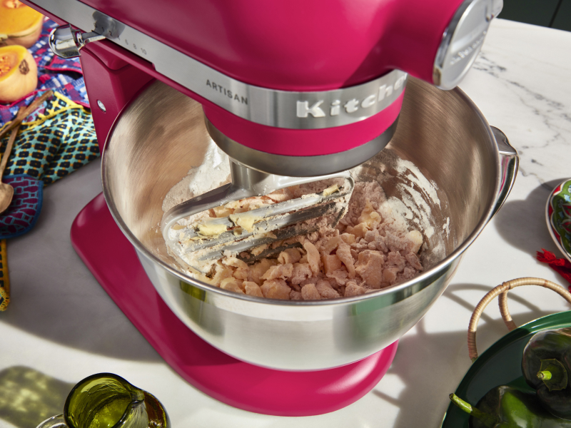A red KitchenAid® stand mixer used to make dough A red KitchenAid® stand mixer used to make dough
