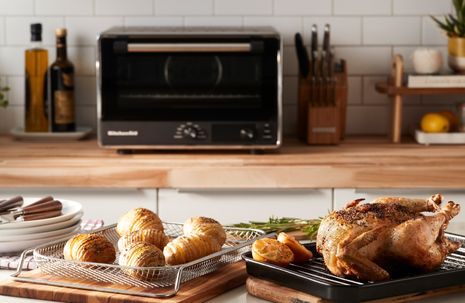 KitchenAid® Air Fryer Countertop Oven in kitchen with air fried potatoes and whole chicken KitchenAid® Air Fryer Countertop Oven in kitchen with air fried potatoes and whole chicken