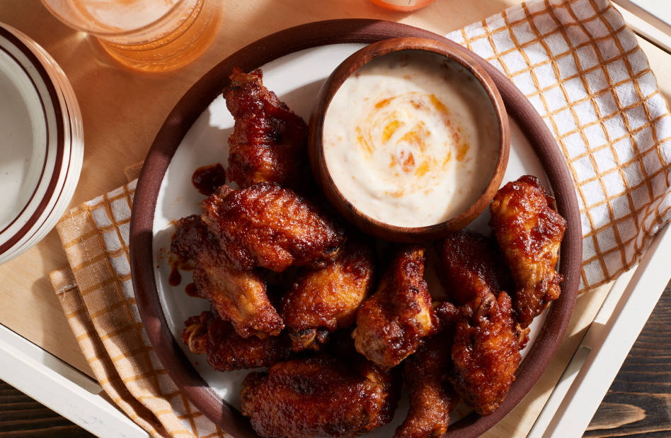 Air fried chicken wings on plate with sauce A plate of air fried chicken wings with a side of ranch