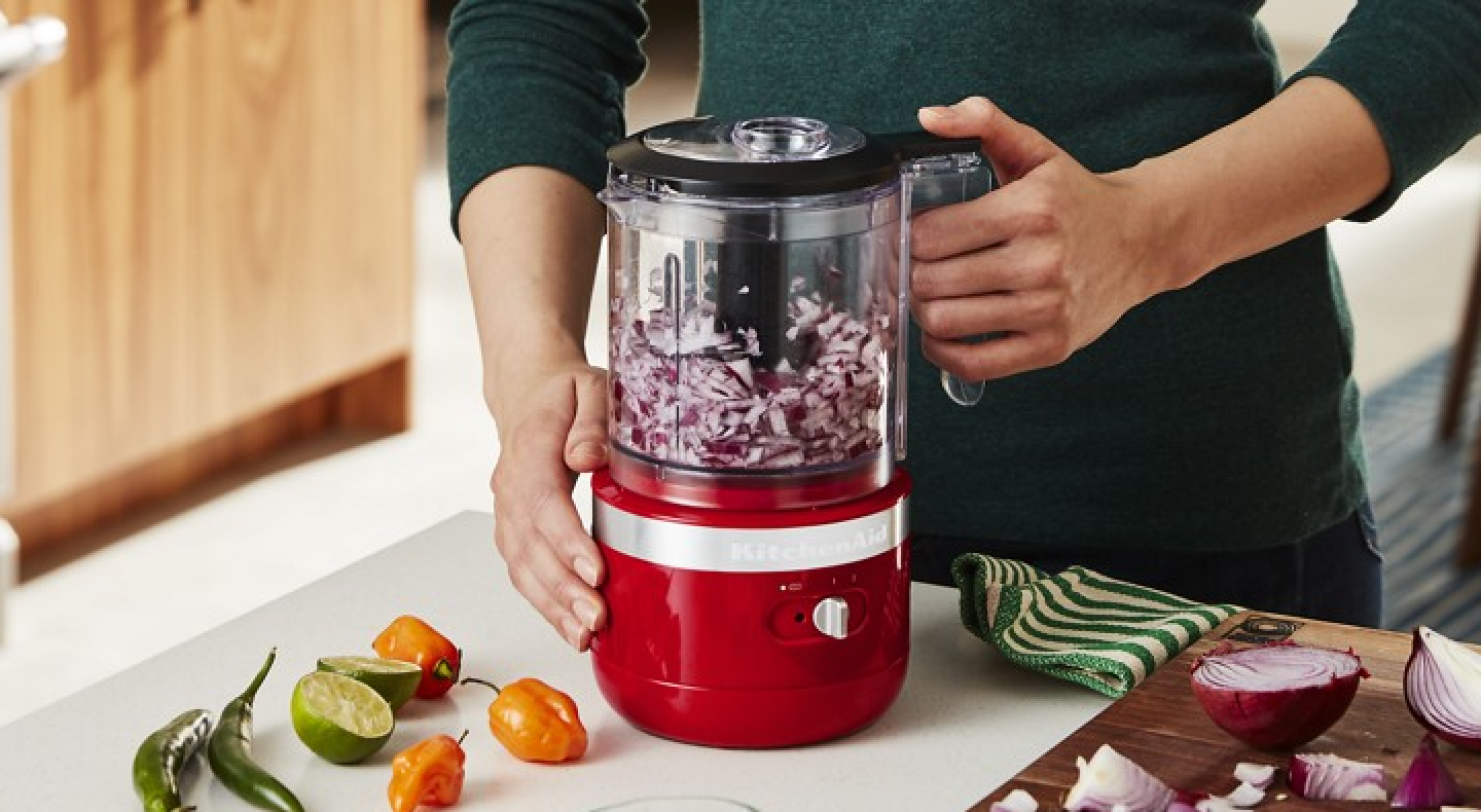 User beginning to chop onions in food processor with additional recipe items in display.  User beginning to chop onions in food processor with additional recipe items in display.