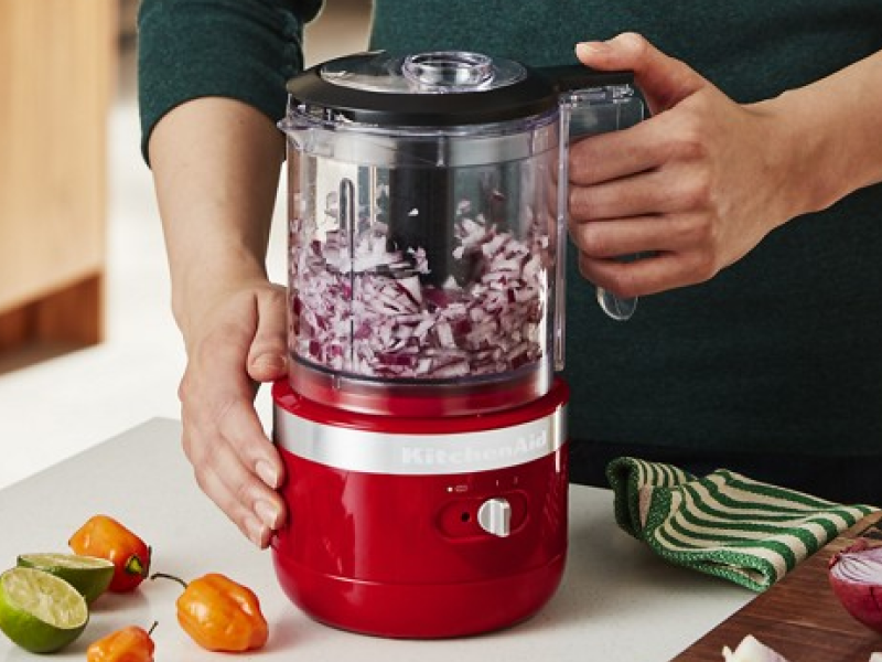 User beginning to chop onions in food processor with additional recipe items in display.  User beginning to chop onions in food processor with additional recipe items in display.