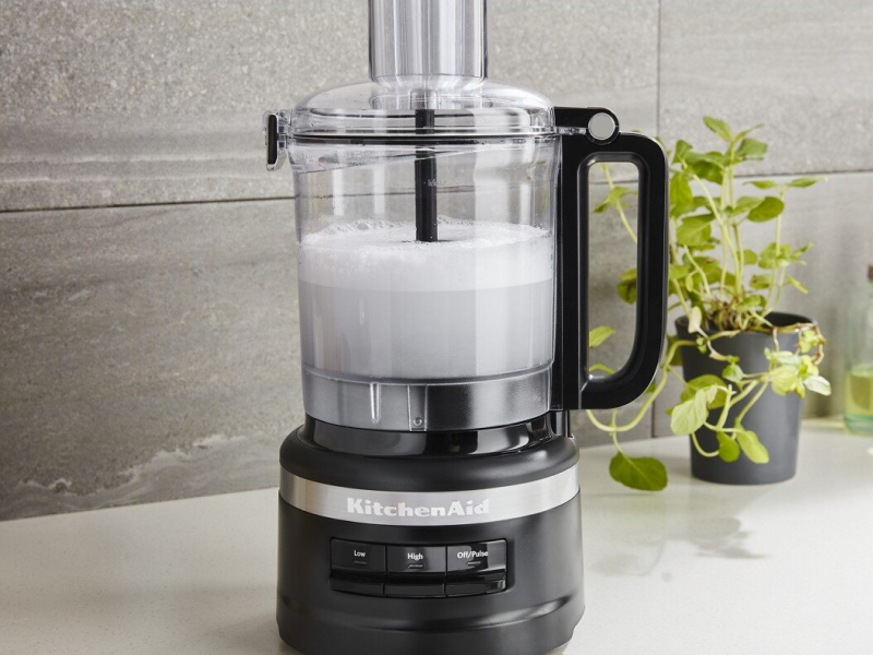 A frothy white liquid in a KitchenAid® food processor A frothy white liquid in a KitchenAid® food processor