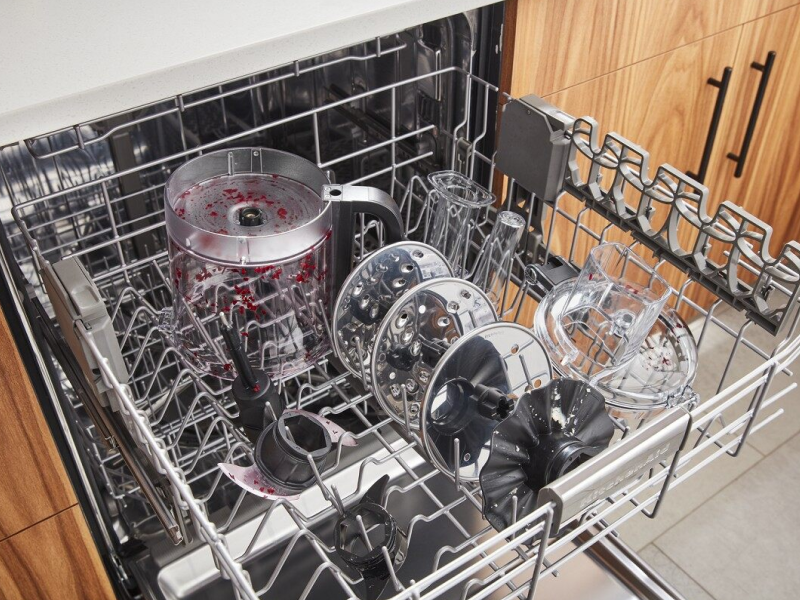 Parts of a disassembled food processor loaded in a dishwasher Parts of a disassembled food processor loaded in a dishwasher