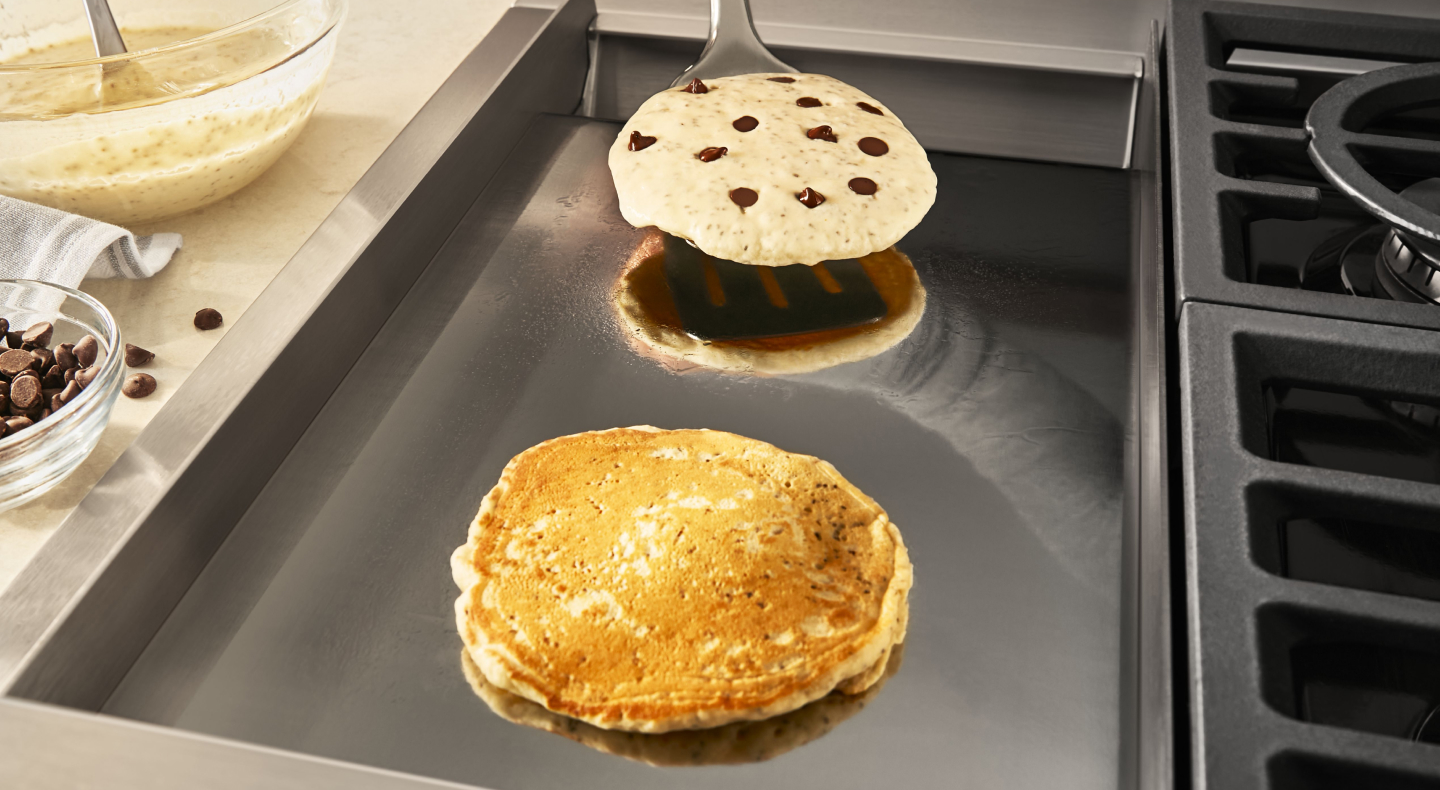 Chocolate chip pancakes on a griddle Chocolate chip pancakes on a griddle