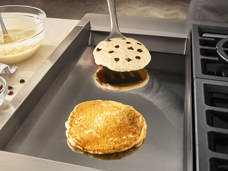 Chocolate chip pancakes on a griddle Chocolate chip pancakes on a griddle