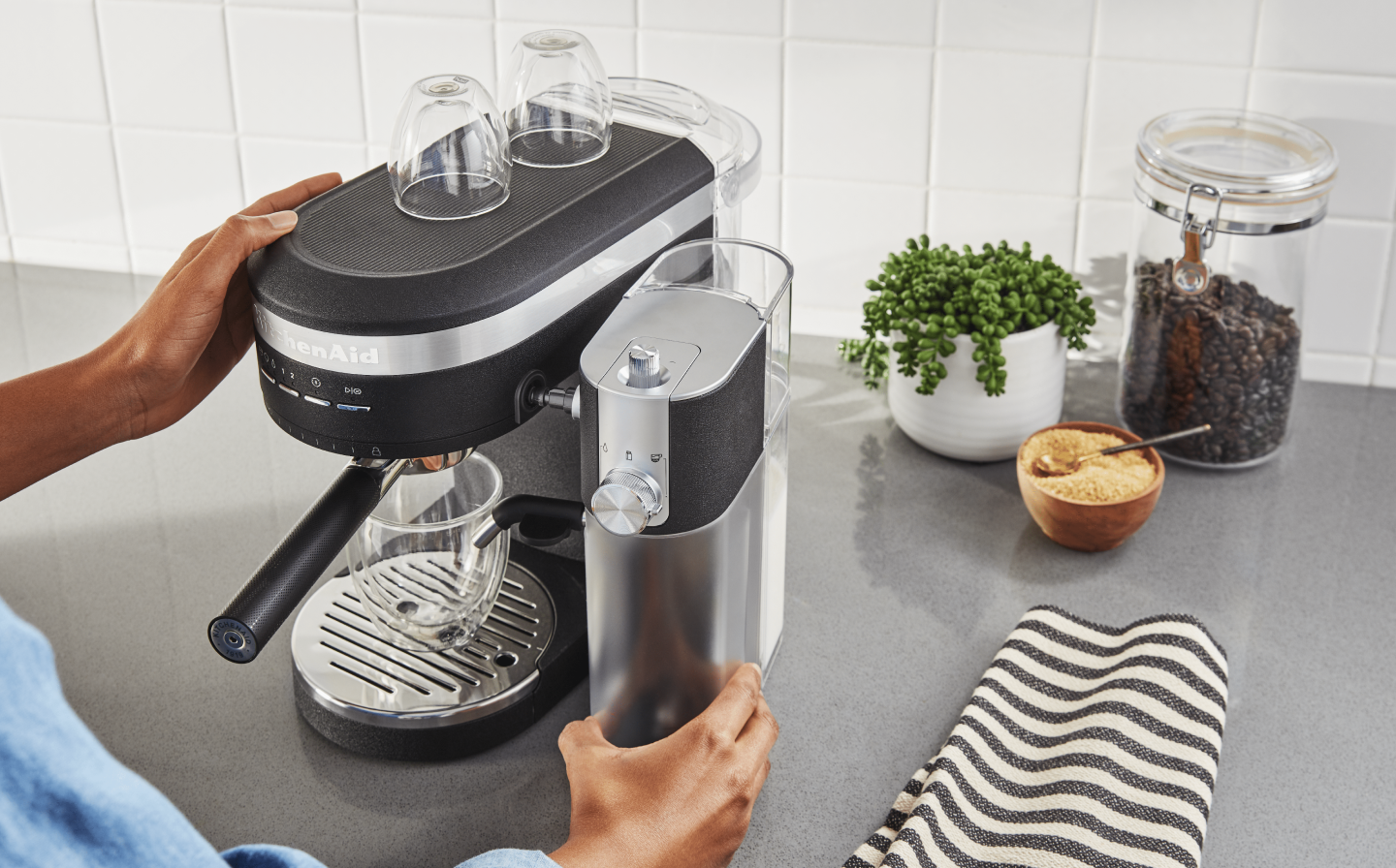 Person removing Automatic Milk Frother Attachment from KitchenAid® Espresso Machine Person removing Automatic Milk Frother Attachment from KitchenAid® Espresso Machine
