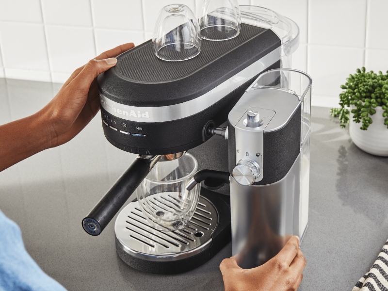 Person removing Automatic Milk Frother Attachment from KitchenAid® Espresso Machine Person removing Automatic Milk Frother Attachment from KitchenAid® Espresso Machine