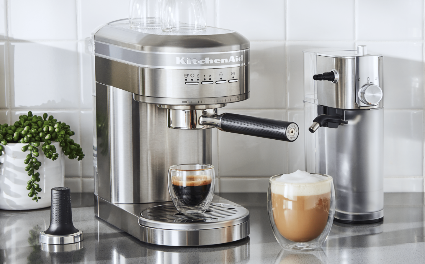 Espresso in a silver KitchenAid® Espresso Machine next to Automatic Milk Frother Attachment Espresso in a silver KitchenAid® Espresso Machine next to Automatic Milk Frother Attachment