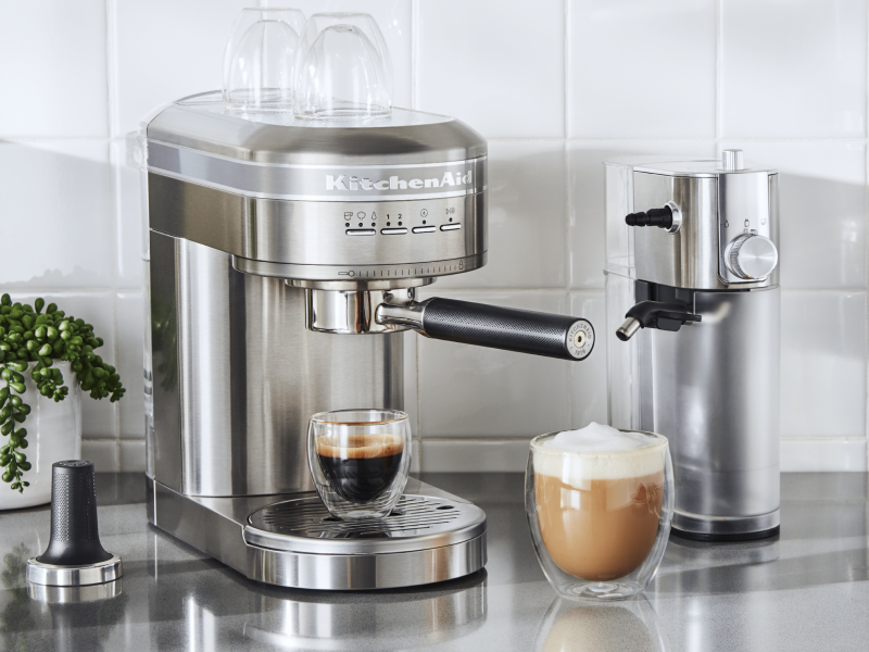 Espresso in a silver KitchenAid® Espresso Machine next to Automatic Milk Frother Attachment Espresso in a silver KitchenAid® Espresso Machine next to Automatic Milk Frother Attachment