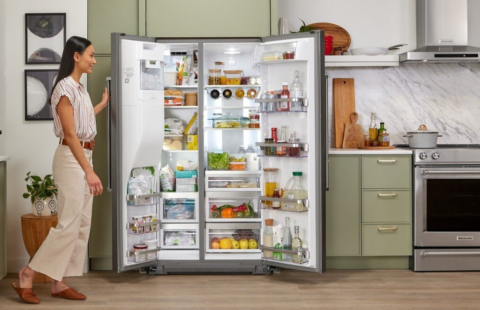 Opened side-by-side refrigerator with a fully-stocked interior Opened side-by-side refrigerator with a fully-stocked interior