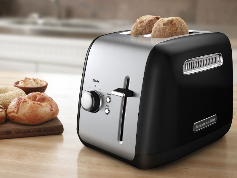 Bagel slices in a silver KitchenAid® toaster on a modern kitchen counter. Bagel slices in a silver KitchenAid® toaster on a modern kitchen counter.