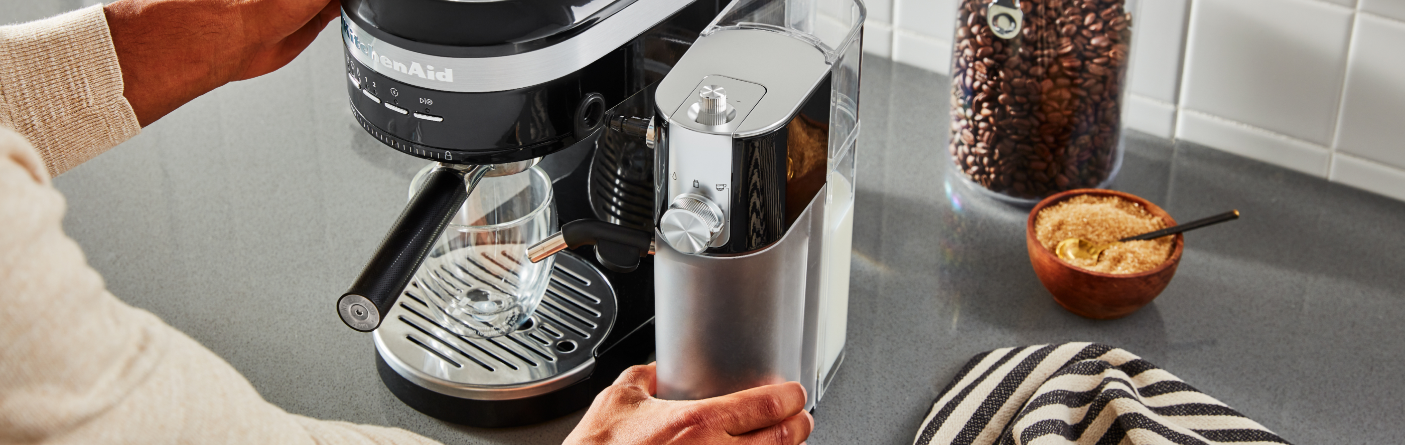 Hand replacing water tank in KitchenAid® espresso maker