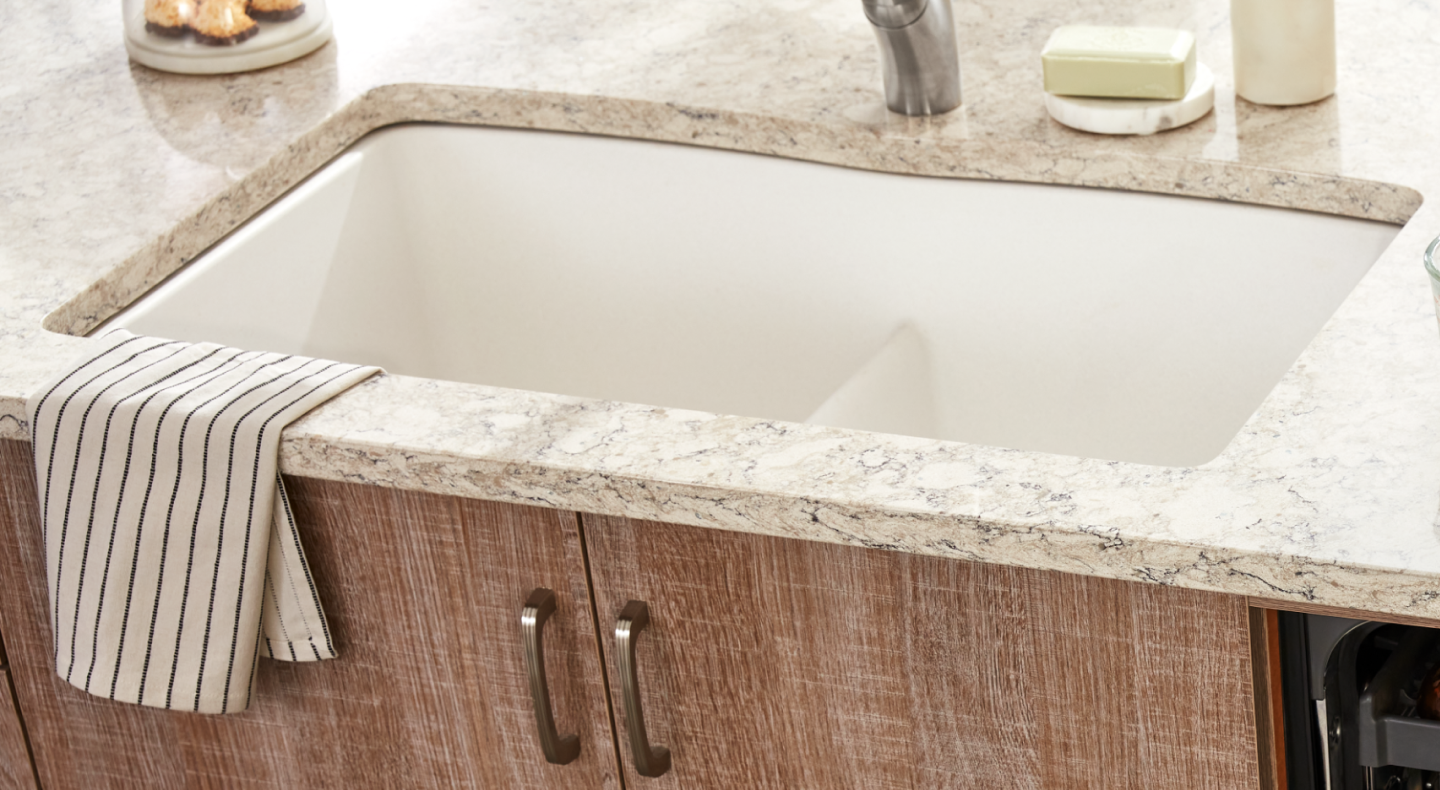 Porcelain sink installed in a white granite countertop Porcelain sink installed in a white granite countertop