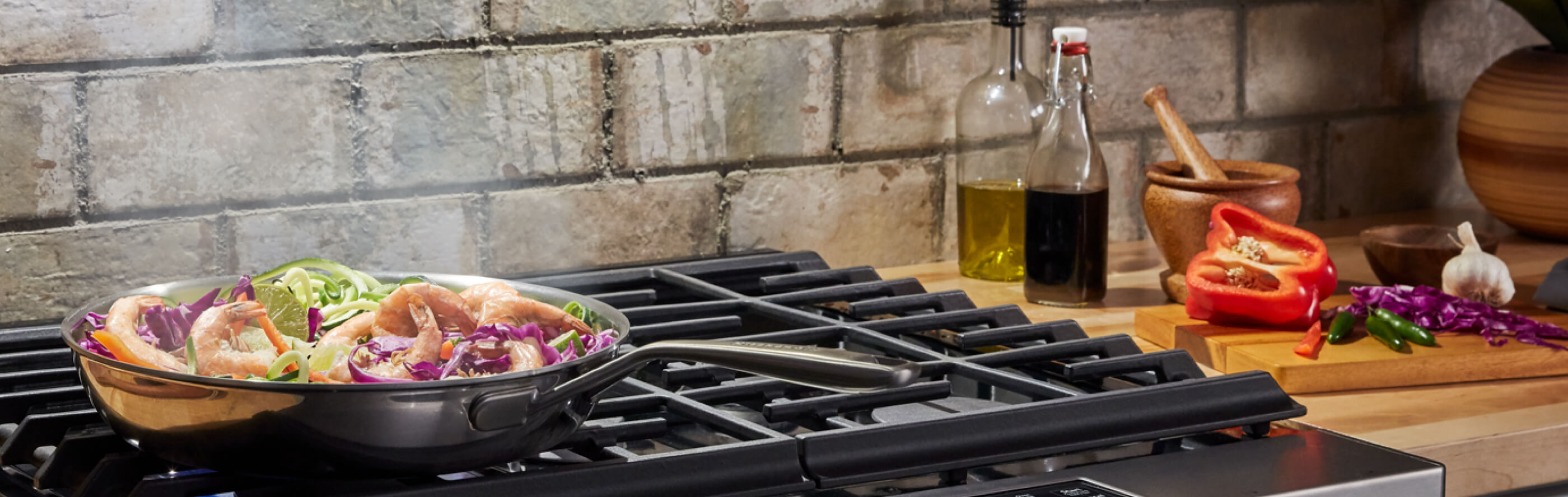 Shrimp stir fry sizzling over a gas range.