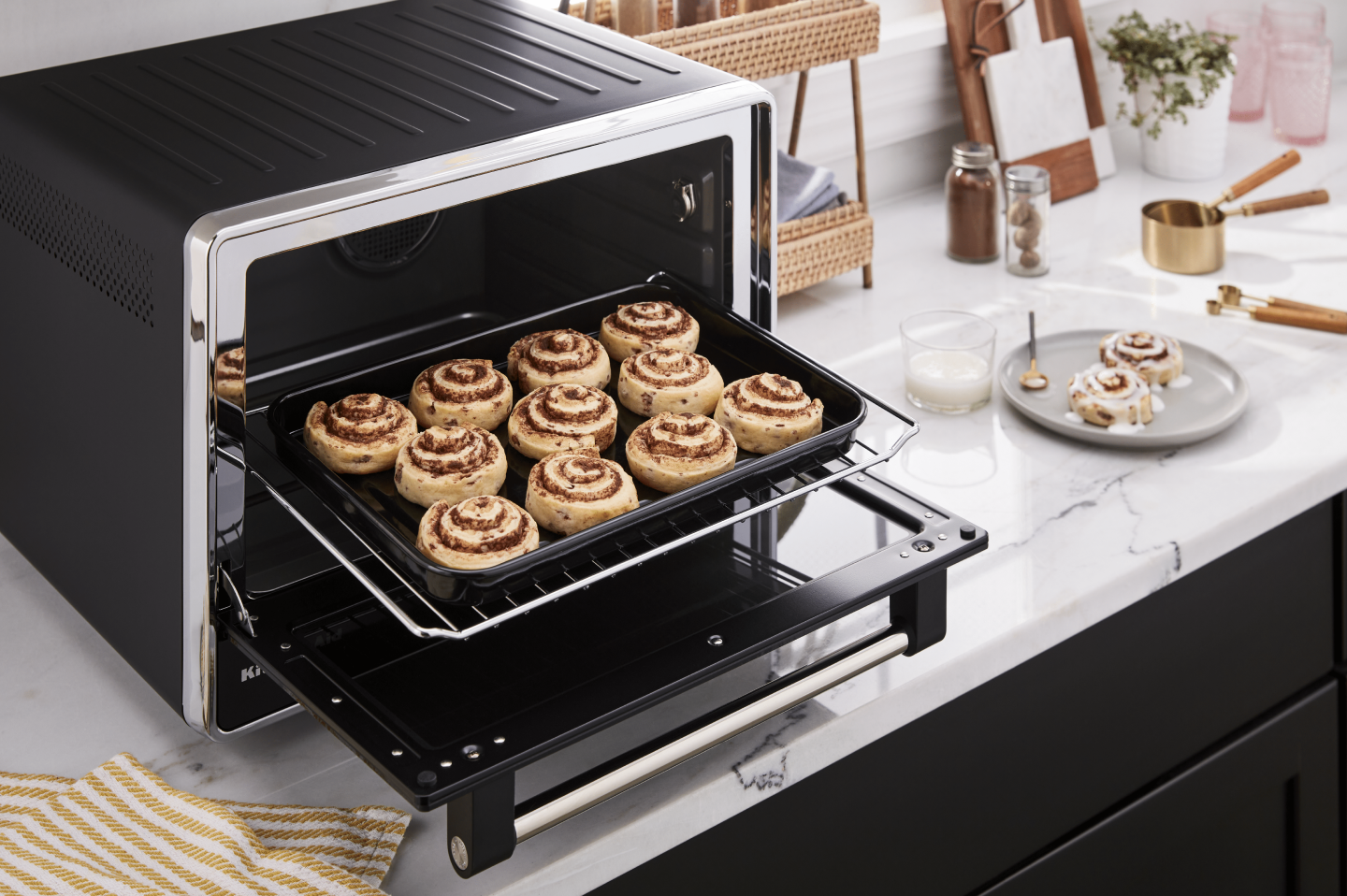 Baking tray of cinnamon rolls inside a countertop oven Baking tray of cinnamon rolls inside a countertop oven