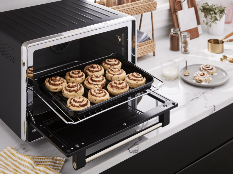 Baking tray of cinnamon rolls inside a countertop oven Baking tray of cinnamon rolls inside a countertop oven