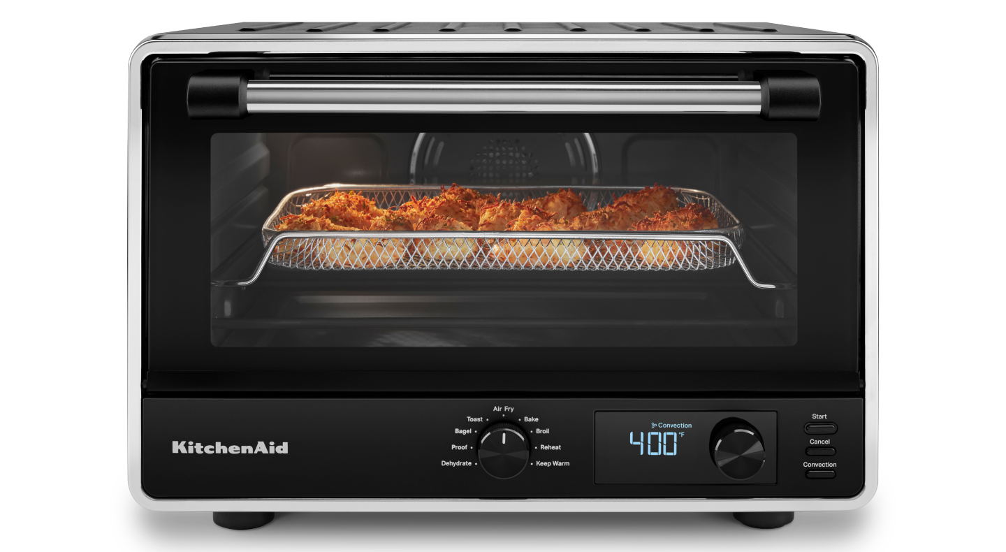 A KitchenAid® countertop oven with a basket of air fryer shrimp. A KitchenAid® countertop oven with a basket of air fryer shrimp.
