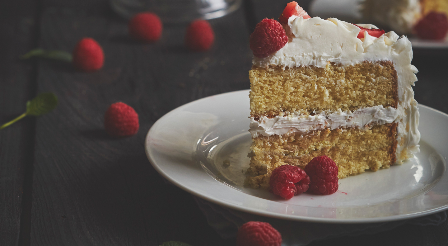 Vanilla butter cake on plate garnished with raspberries Vanilla butter cake on plate garnished with raspberries