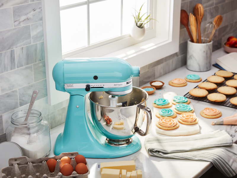 Bright blue KitchenAid® stand mixer next to decorated sugar cookies Bright blue KitchenAid® stand mixer next to decorated sugar cookies