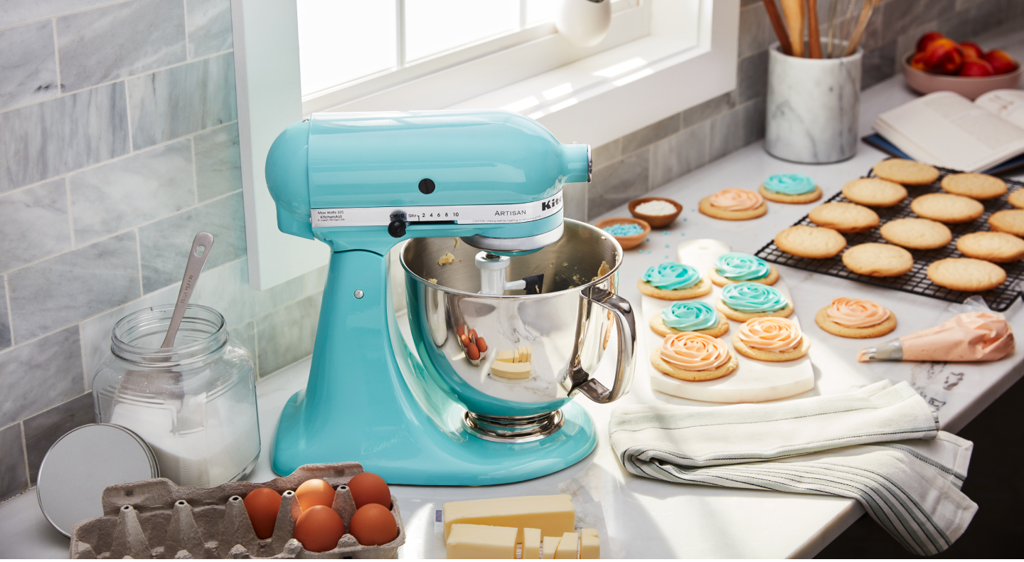 Bright blue KitchenAid® stand mixer next to decorated sugar cookies Bright blue KitchenAid® stand mixer next to decorated sugar cookies