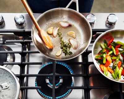 Aromatics sauteing in a frying pan