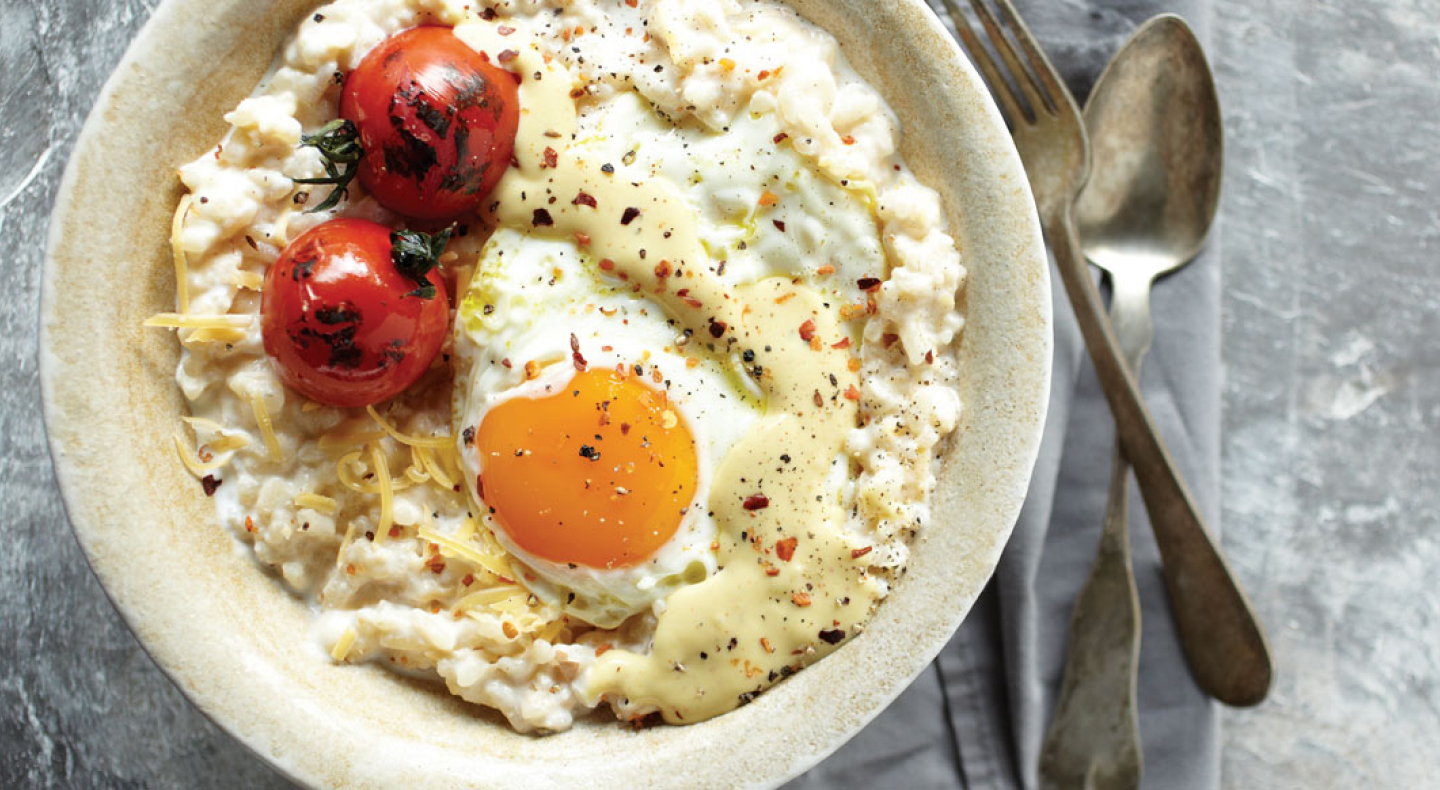 Risotto topped with grape tomatoes and a fried egg Risotto topped with grape tomatoes and a fried egg