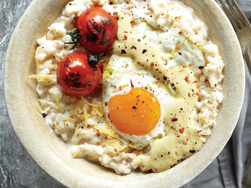 Risotto topped with grape tomatoes and a fried egg Risotto topped with grape tomatoes and a fried egg