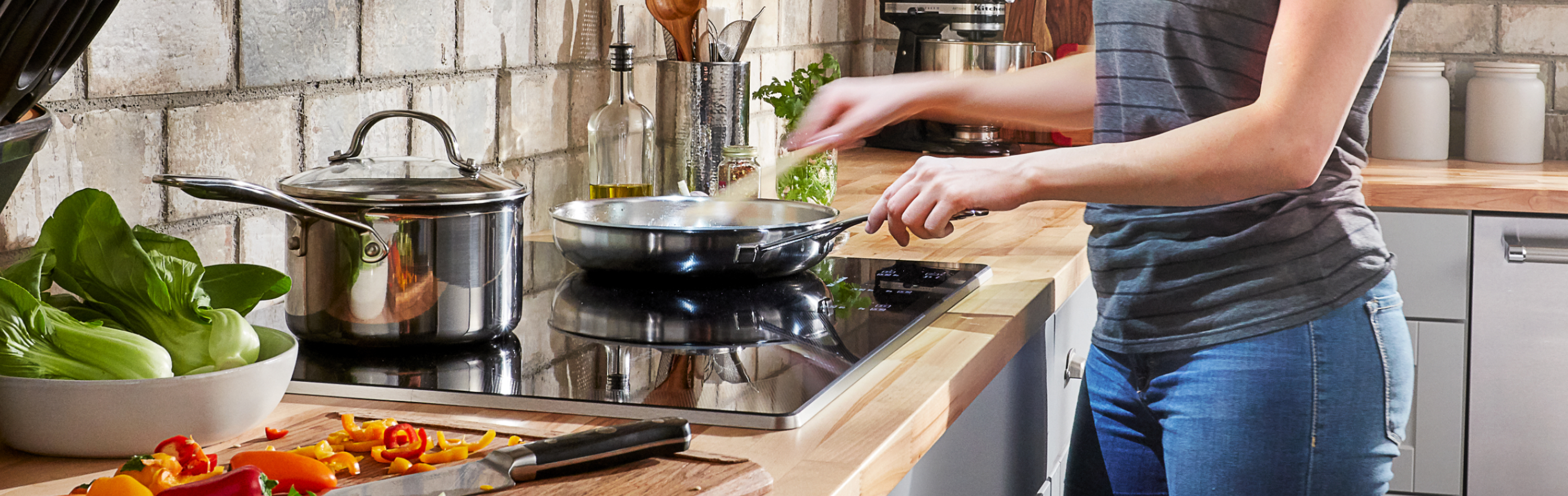 Person cooking on a glass surface cooktop