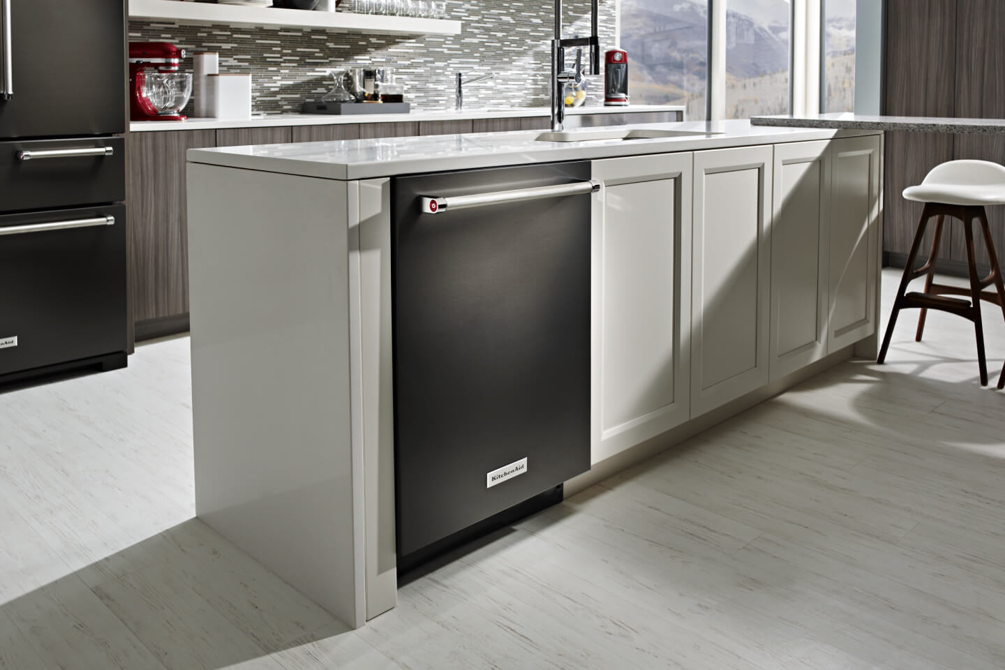 Black KitchenAid® top control dishwasher in a kitchen island