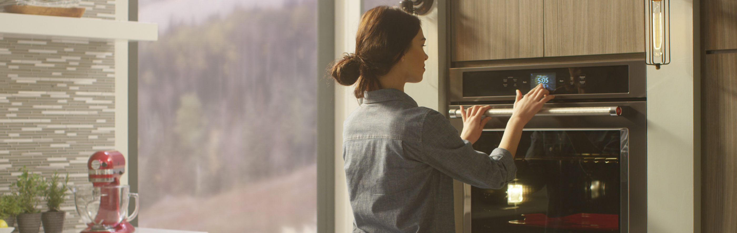 Person selecting settings on KitchenAid® wall oven