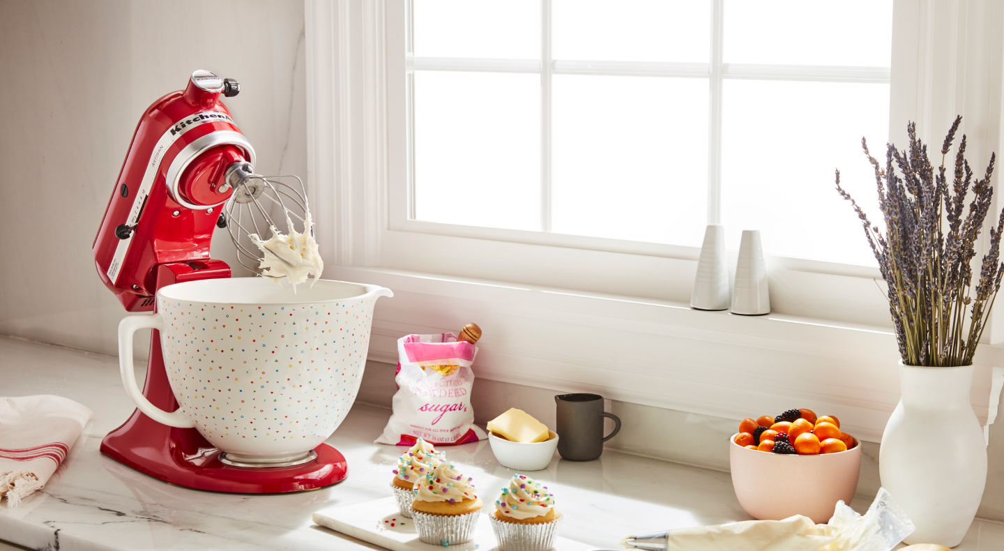 Red KitchenAid® stand mixer with a ceramic bowl