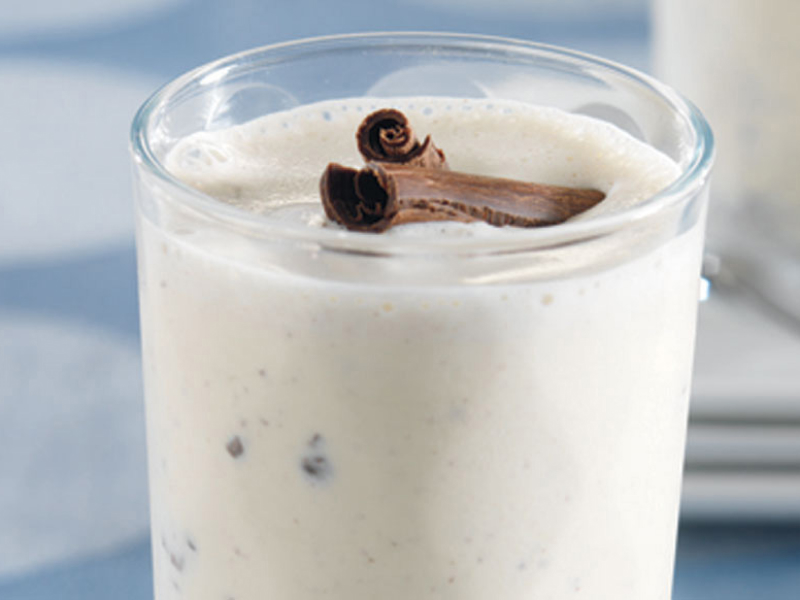 Close-up of vanilla milkshake with mix-ins and cinnamon sticks on top Close-up of vanilla milkshake with mix-ins and cinnamon sticks on top