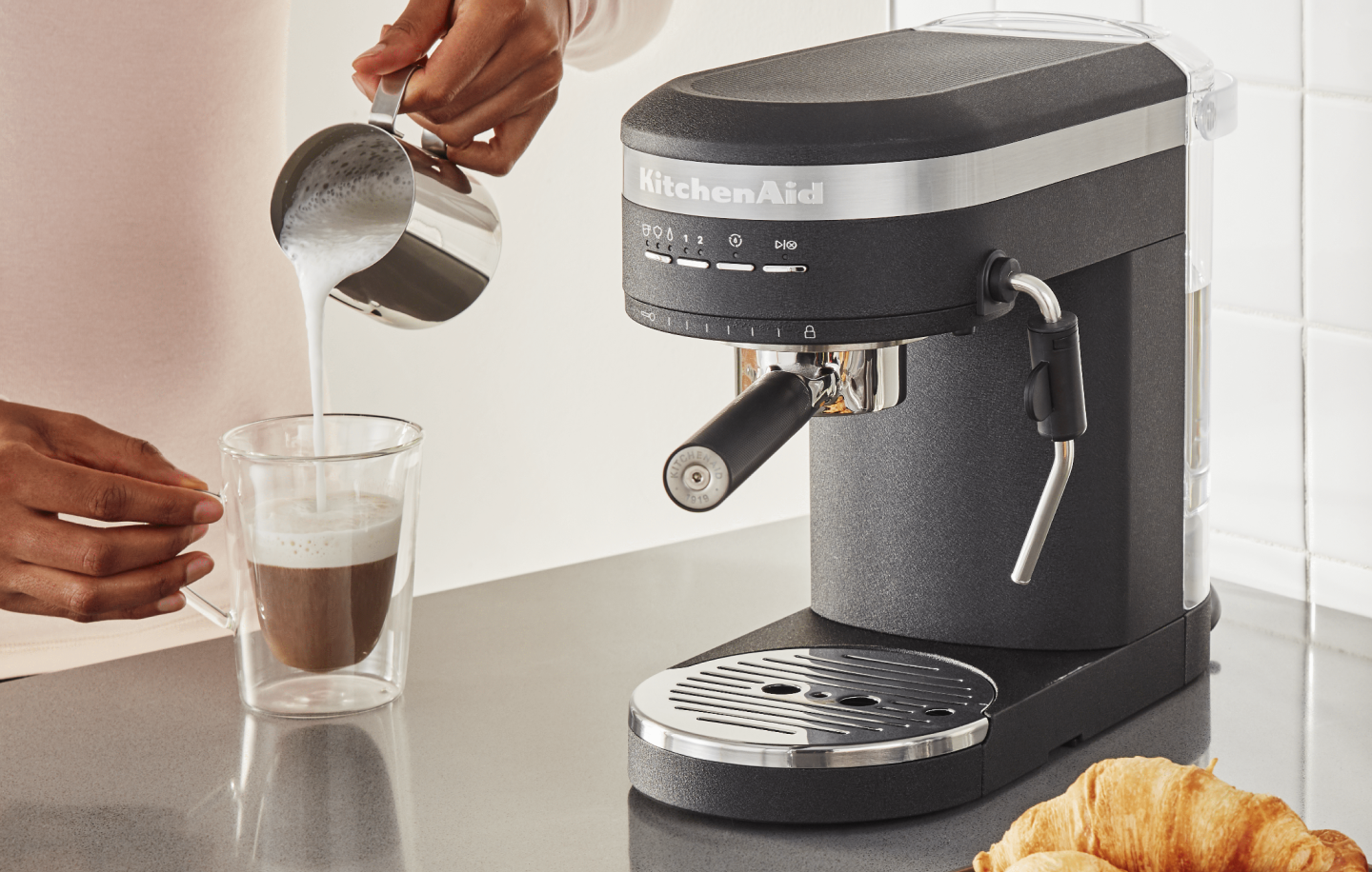 Steamed milk being poured over espresso Steamed milk being poured over espresso